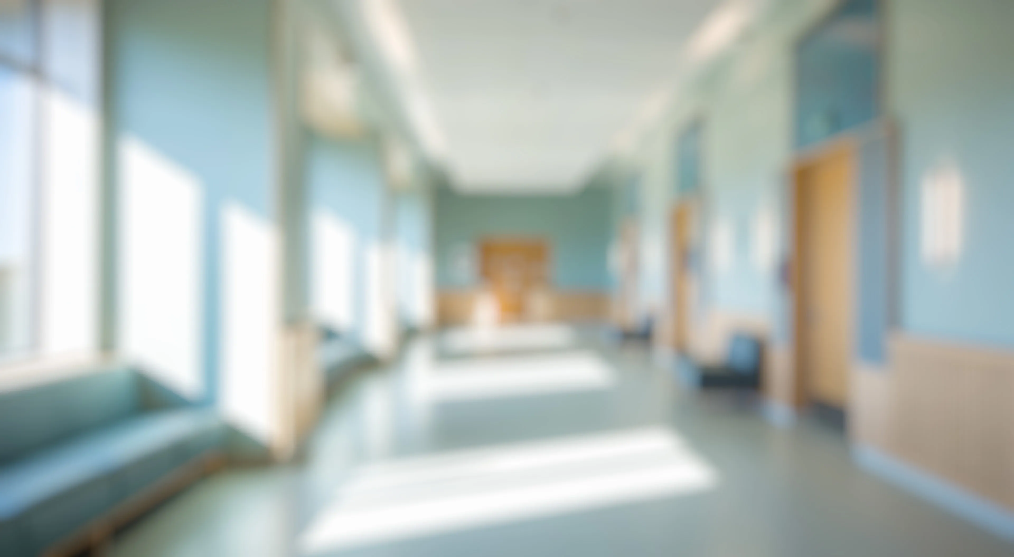 A blurred image of an empty clinic hallway