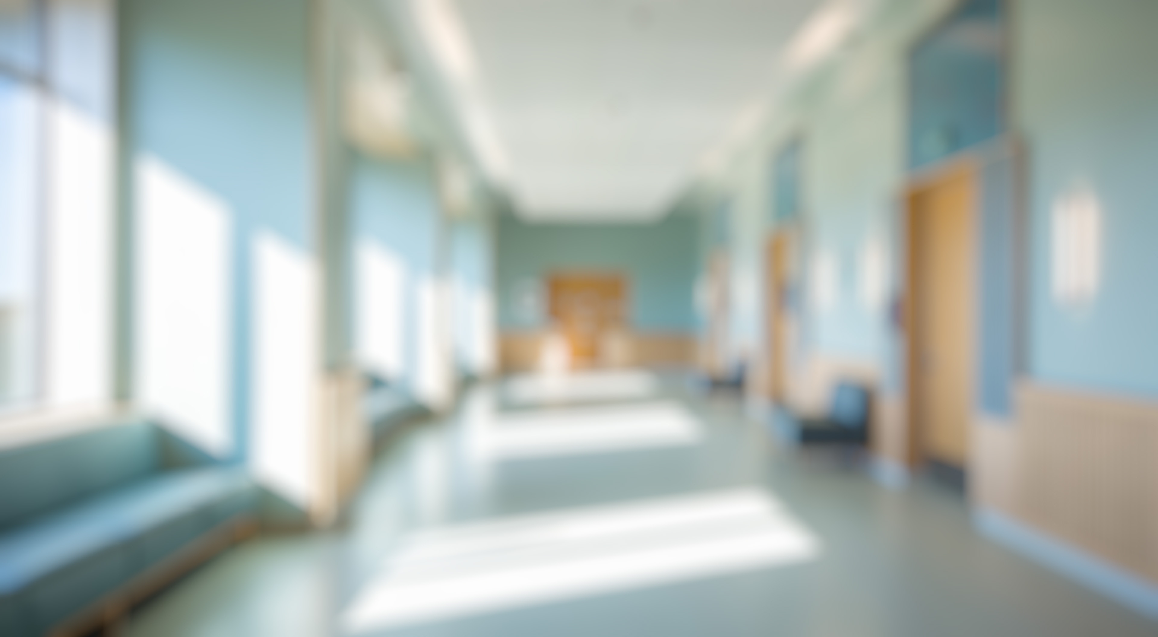 A blurred image of an empty clinic hallway